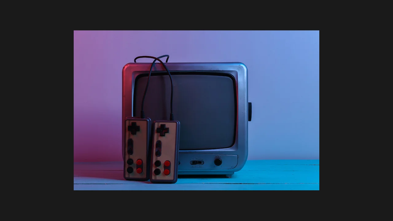 A retro CRT television with two retro game controllers in front of it